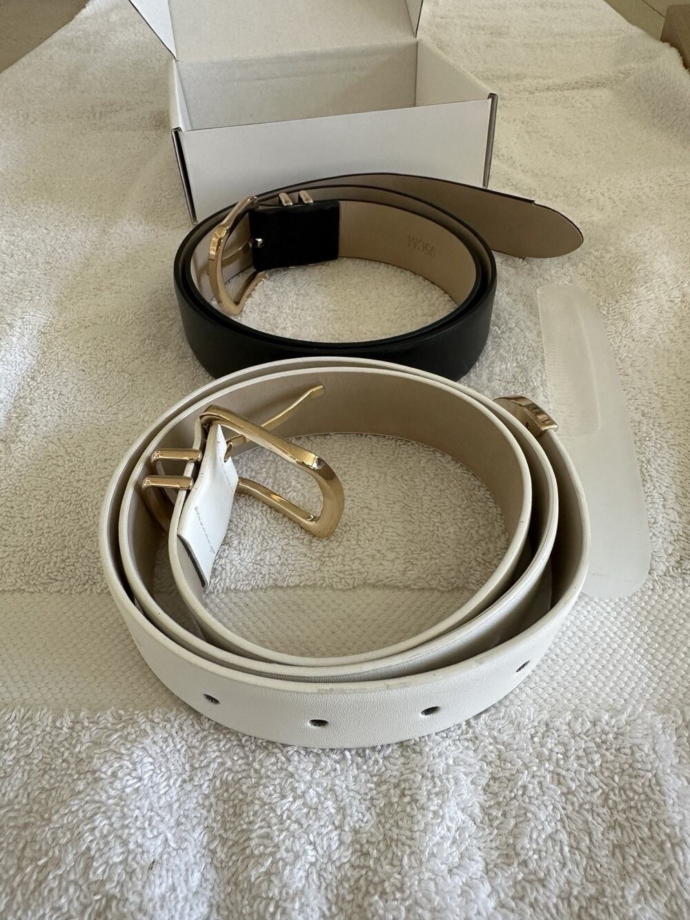 2 Belts. One Black, One White. 95cm. See Pictures For Missing Piece.